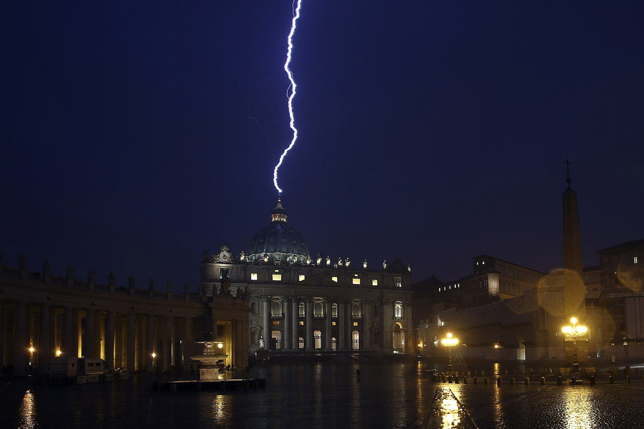 A flash of lighting is seen over St.Peter's Basilica during a rainstorm at Vatican in this picture provided by Ansa on February 11, 2013. Pope Benedict stunned the Roman Catholic Church on Monday when he announced he would stand down, the first pope to do so in 700 years, saying he no longer had the mental and physical strength to carry on. REUTERS/ANSA/ Alessandro Di Meo ( VATICAN - Tags: RELIGION) ATTENTION EDITORS - NO COMMERCIAL USE. NO MAGS. NO SALES. NO ARCHIVES. FOR EDITORIAL USE ONLY. NOT FOR SALE FOR MARKETING OR ADVERTISING CAMPAIGNS. THIS IMAGE HAS BEEN SUPPLIED BY A THIRD PARTY. IT IS DISTRIBUTED, EXACTLY AS RECEIVED BY REUTERS, AS A SERVICE TO CLIENTS. ITALY OUT. NO COMMERCIAL OR EDITORIAL SALES IN ITALY